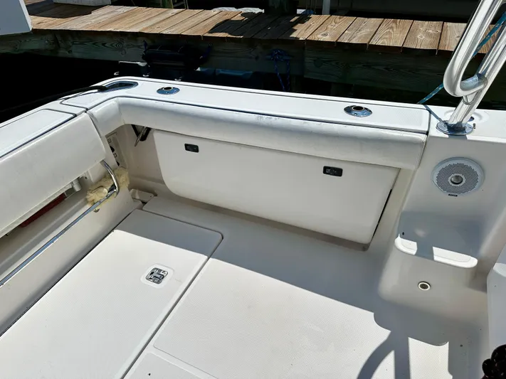  Yacht Photos Pics 2004 Tiara Yachts 3200 Open boat interior with seating and speaker, docked by wooden pier.