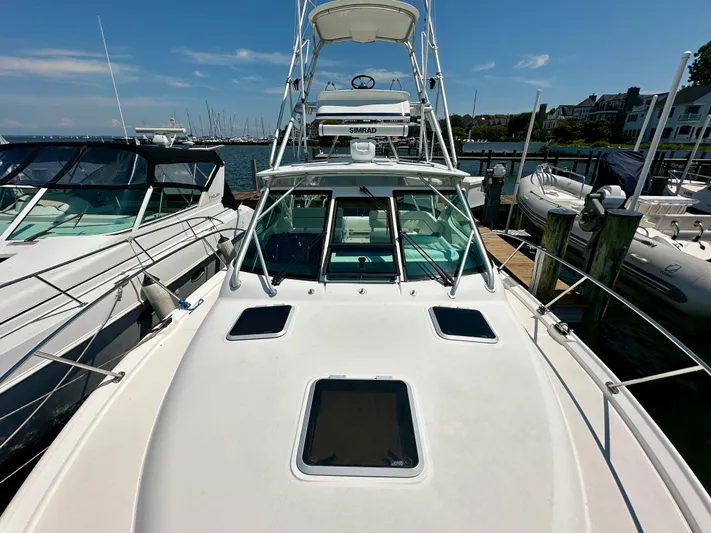  Yacht Photos Pics 2004 Tiara Yachts 3200 Open docked, showcasing sleek design and spacious deck.