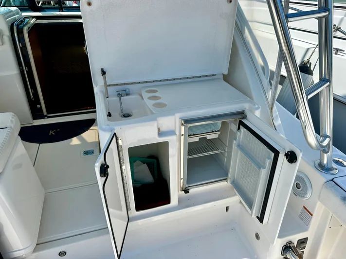  Yacht Photos Pics 2004 Tiara Yachts 3200 Open boat interior with open storage and mini fridge.