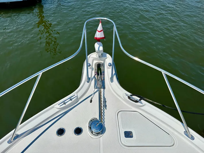 Yacht Photos Pics Bow of 2004 Tiara Yachts 3200 Open, featuring anchor and railing, on calm water.