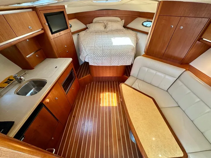  Yacht Photos Pics 2004 Tiara Yachts 3200 Open interior with bed, kitchenette, and seating area.