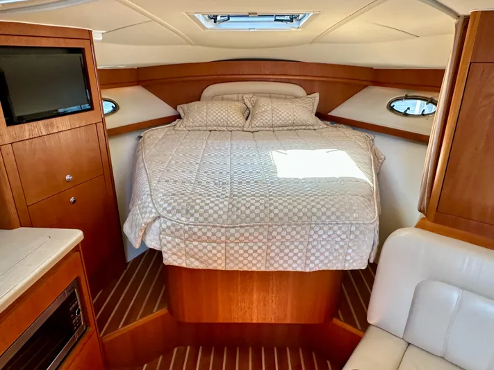  Yacht Photos Pics Luxurious cabin interior of 2004 Tiara Yachts 3200 Open with cozy bed and wood finish.