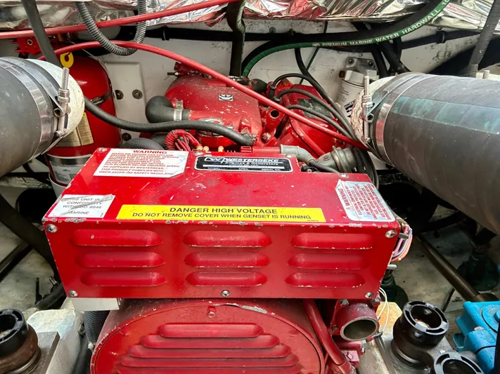 Yacht Photos Pics Engine compartment of a 2004 Tiara Yachts 3200 Open, featuring a red generator.