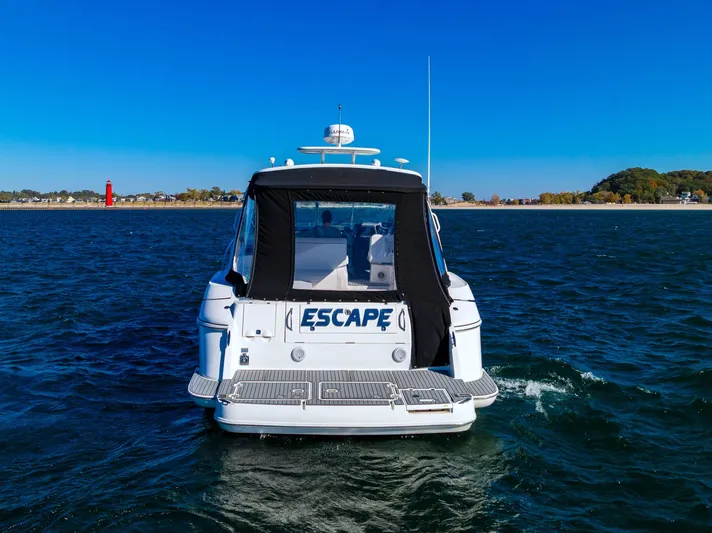 Escape Yacht Photos Pics 2005 Cruisers Yachts 440 Express on water, rear view with "Escape" name visible.