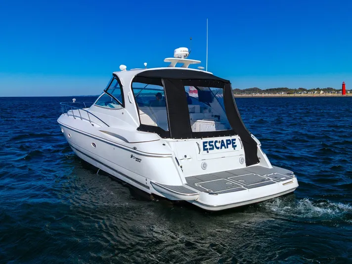Escape Yacht Photos Pics 2005 Cruisers Yachts 440 Express on open water, rear view with "Escape" name visible.