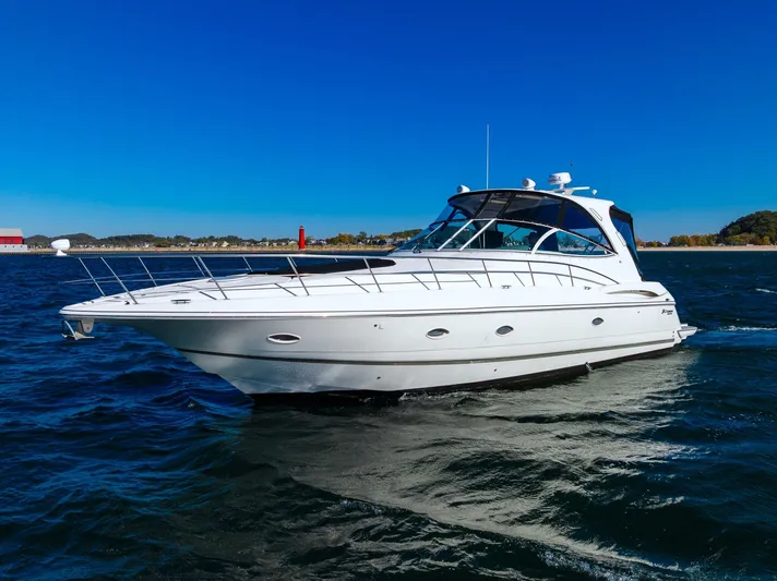 Escape Yacht Photos Pics 2005 Cruisers Yachts 440 Express on open water under clear blue sky.