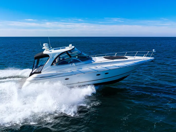 Escape Yacht Photos Pics 2005 Cruisers Yachts 440 Express cruising on open sea under clear blue sky.