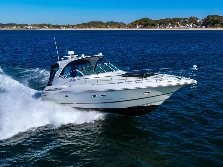 Escape Yacht Photos Pics 2005 Cruisers Yachts 440 Express cruising on open water, scenic coastal background.