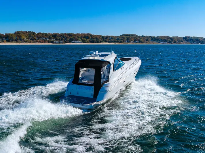 Escape Yacht Photos Pics 2005 Cruisers Yachts 440 Express cruising on open water near a scenic coastline.