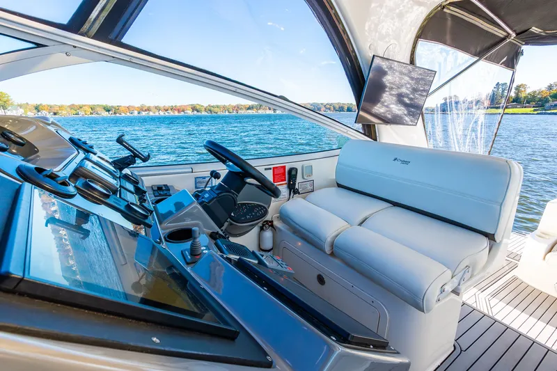 Escape Yacht Photos Pics 2005 Cruisers Yachts 440 Express helm with modern controls and scenic water view.