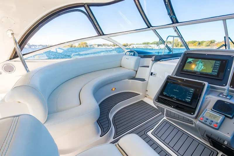 Escape Yacht Photos Pics Luxurious 2005 Cruisers Yachts 440 Express interior with navigation screens and plush seating.