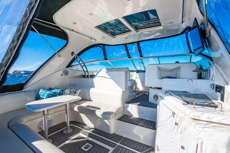 Escape Yacht Photos Pics 2005 Cruisers Yachts 440 Express interior with white seating, table, and panoramic windows.
