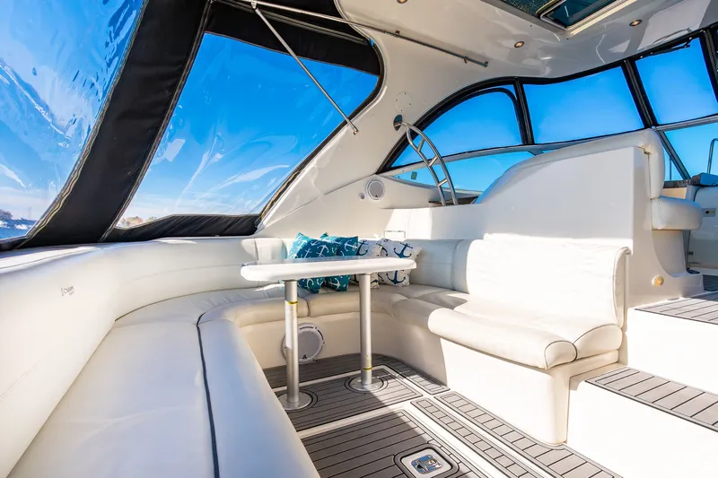 Escape Yacht Photos Pics Luxurious 2005 Cruisers Yachts 440 Express interior with white seating and panoramic windows.