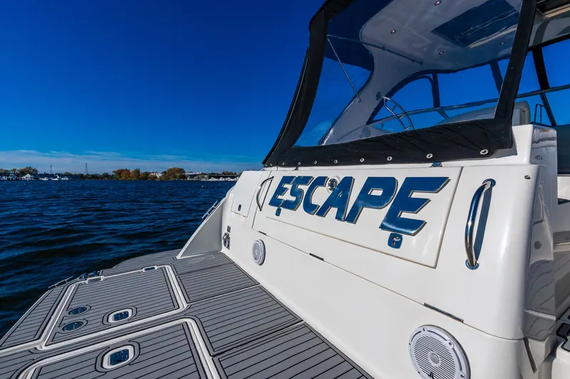 Escape Yacht Photos Pics 2005 Cruisers Yachts 440 Express on water, featuring "Escape" name on stern.
