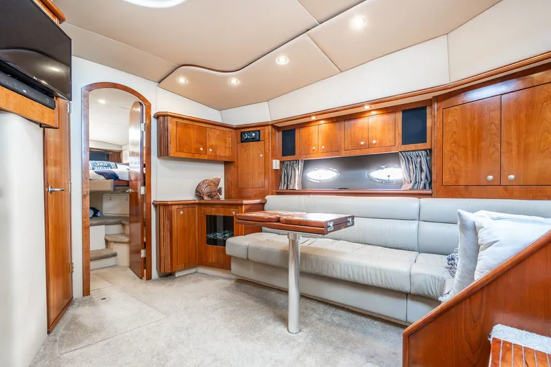 Escape Yacht Photos Pics Luxurious 2005 Cruisers Yachts 440 Express interior with elegant wood cabinetry and plush seating.