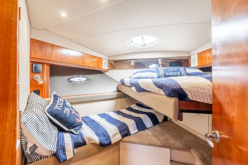 Escape Yacht Photos Pics 2005 Cruisers Yachts 440 Express cabin with cozy bunk beds and nautical decor.