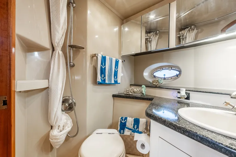 Escape Yacht Photos Pics Luxurious 2005 Cruisers Yachts 440 Express bathroom with nautical decor and modern amenities.