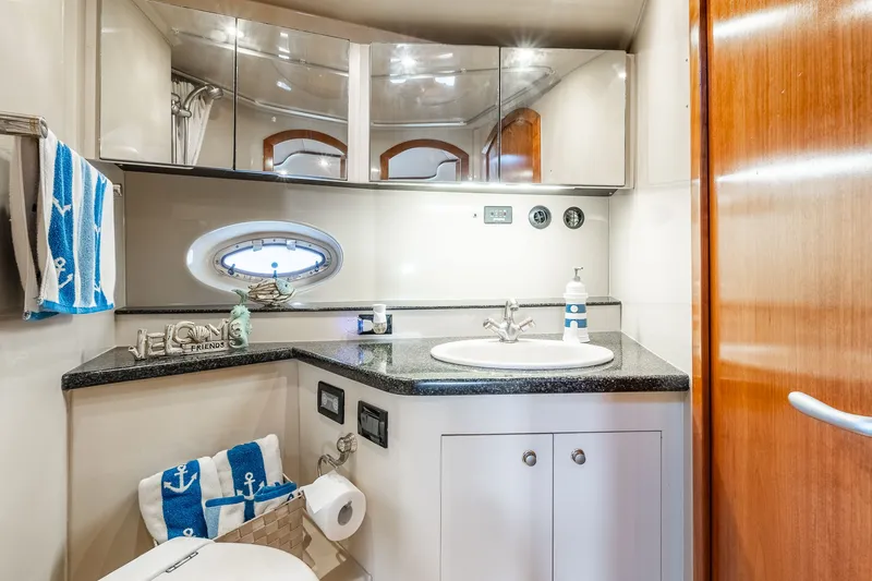 Escape Yacht Photos Pics Luxurious 2005 Cruisers Yachts 440 Express bathroom with modern fixtures and nautical decor.