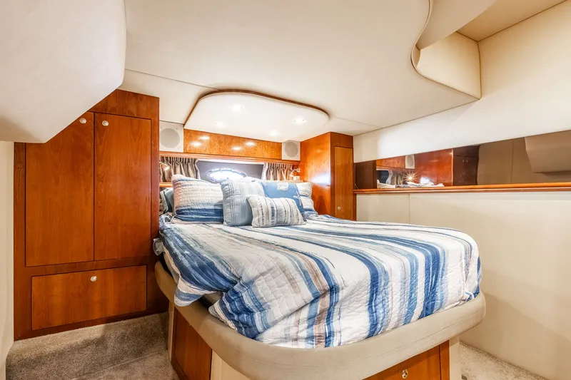 Escape Yacht Photos Pics Luxurious cabin interior of 2005 Cruisers Yachts 440 Express with cozy bedding.