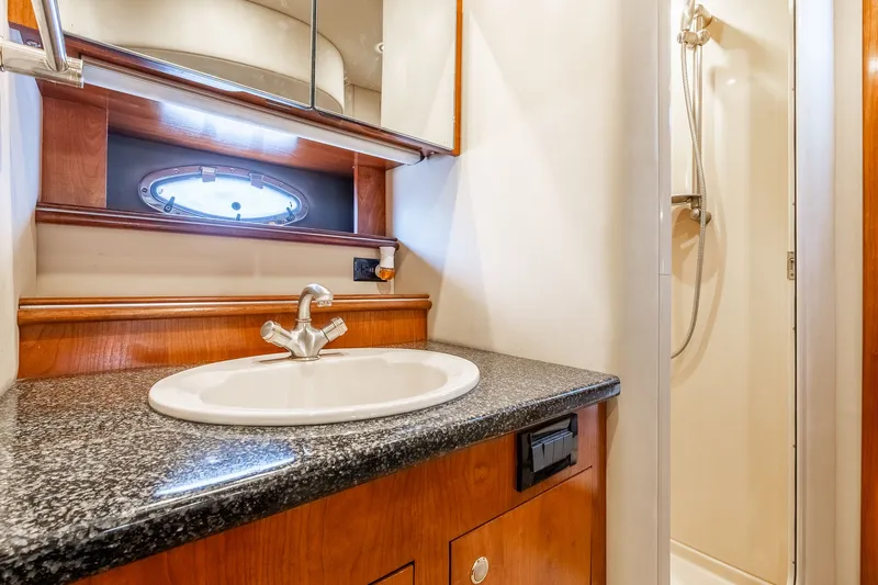 Escape Yacht Photos Pics Luxurious bathroom in 2005 Cruisers Yachts 440 Express with granite countertop and shower.