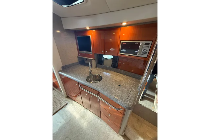 Dream Maker II Yacht Photos Pics 2005 Formula 37 Performance Cruiser kitchen with sleek countertop, sink, and built-in microwave.