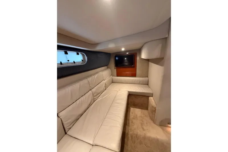 Dream Maker II Yacht Photos Pics Interior of 2005 Formula 37 Performance Cruiser with beige seating and wall-mounted TV.