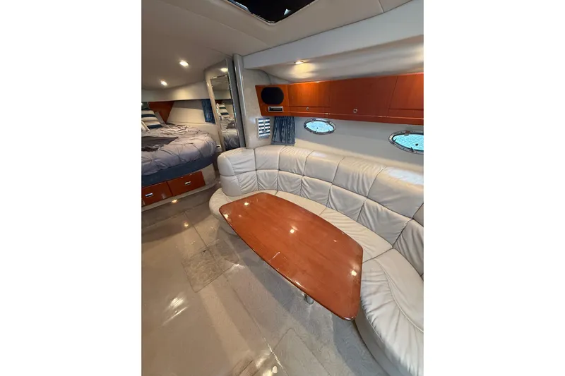 Dream Maker II Yacht Photos Pics Interior of 2005 Formula 37 Performance Cruiser with white leather seating and wooden table.
