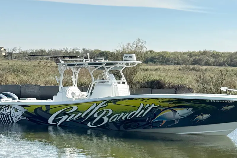  Yacht Photos Pics 2016 Yellowfin 36 Offshore boat with "Gulf Bandit" graphics on calm water.
