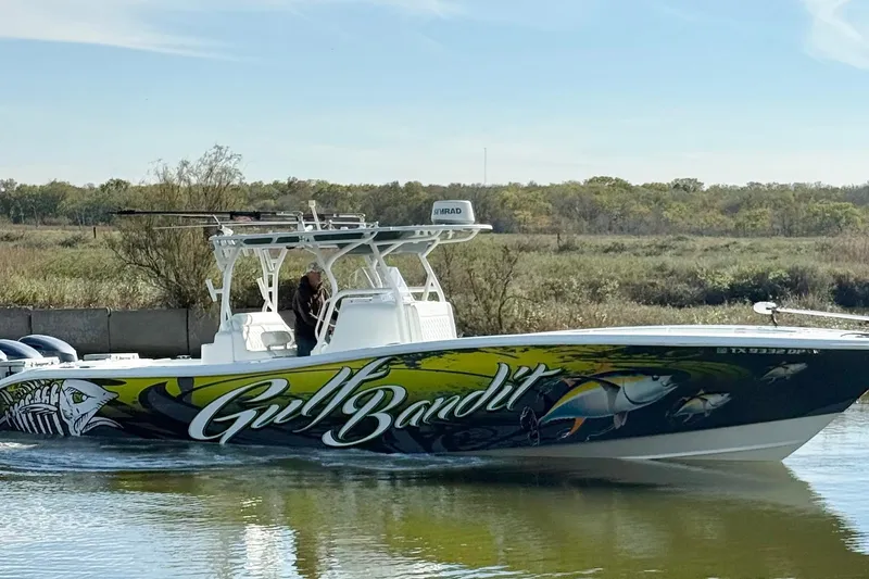  Yacht Photos Pics 2016 Yellowfin 36 Offshore boat with vibrant "Gulf Bandit" graphics on calm water.