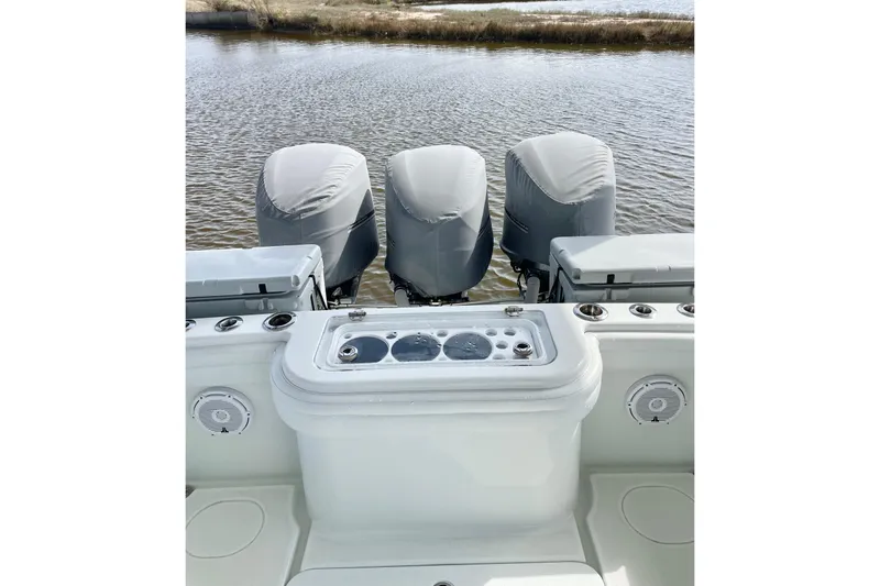  Yacht Photos Pics 2018 Yellowfin 36 Offshore boat with triple covered engines on calm water.