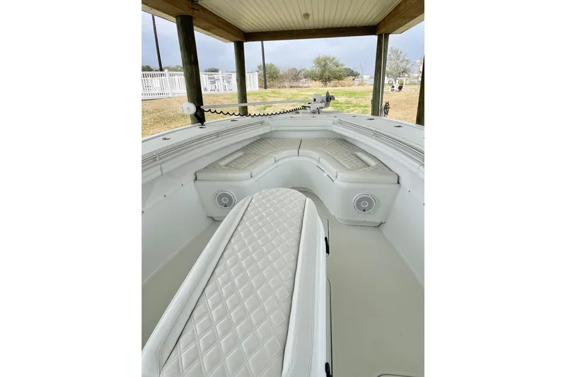  Yacht Photos Pics 2018 Yellowfin 36 Offshore boat interior with cushioned seating and speakers.