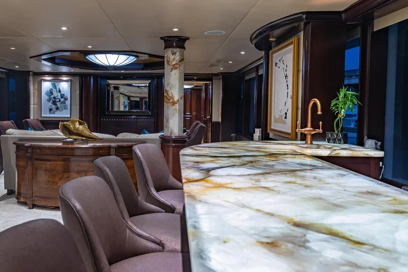 Starship Yacht Photos Pics Luxurious yacht interior with marble countertops, elegant seating, and modern decor, Van Mill Custom 1988.