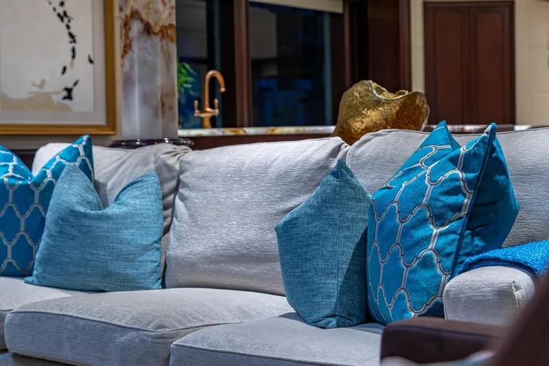 Starship Yacht Photos Pics Luxurious yacht interior with blue cushions on a gray sofa, Van Mill Custom 1988.