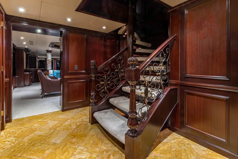 Starship Yacht Photos Pics Luxurious wooden staircase with ornate railing in a Van Mill 1988 custom interior.