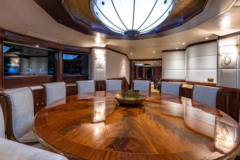 Starship Yacht Photos Pics Luxurious dining area in 1988 Van Mill Custom yacht with elegant wood table and plush seating.