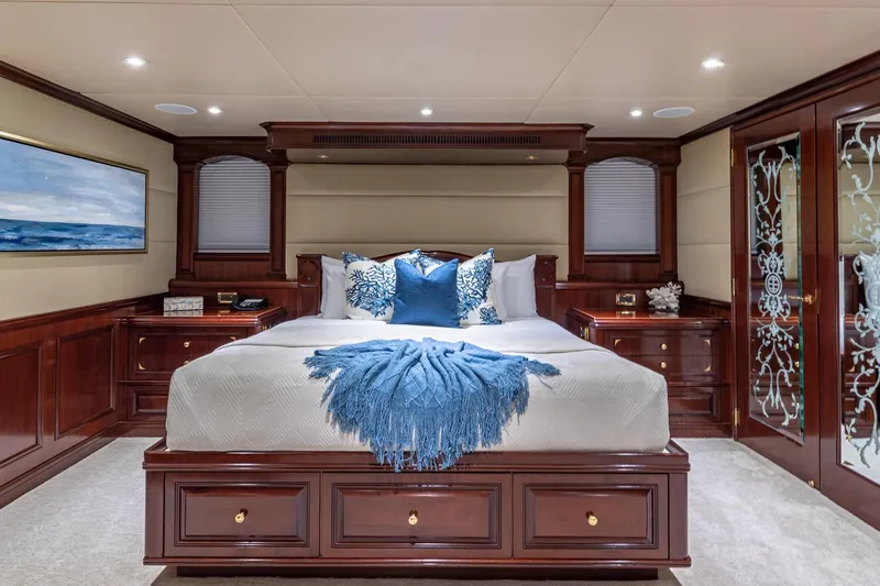 Starship Yacht Photos Pics Luxurious 1988 Van Mill Custom yacht bedroom with elegant wood finishes and blue accents.