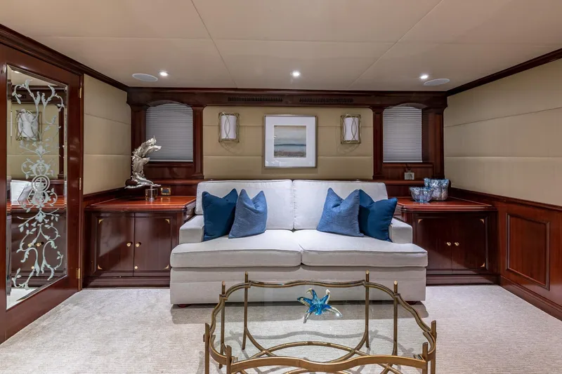 Starship Yacht Photos Pics Luxurious 1988 Van Mill yacht interior with elegant sofa, blue cushions, and decorative accents.