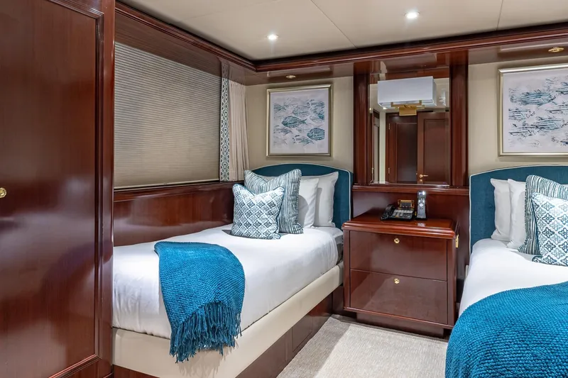 Starship Yacht Photos Pics Luxurious 1988 Van Mill Custom yacht cabin with twin beds, elegant wood finish, and blue accents.