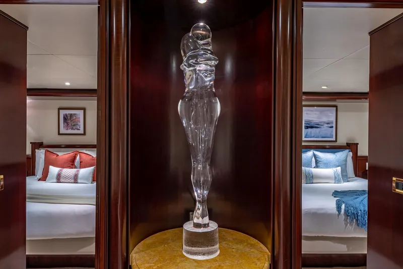 Starship Yacht Photos Pics Luxurious yacht interior with elegant glass sculpture, flanked by two cozy bedrooms. Van Mill 1988.