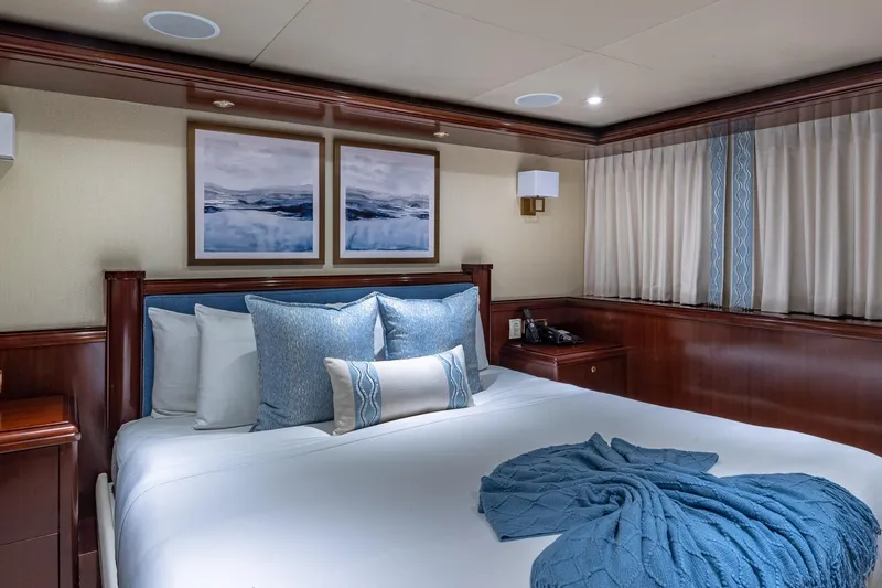 Starship Yacht Photos Pics Luxurious 1988 Van Mill Custom yacht bedroom with elegant decor and plush bedding.