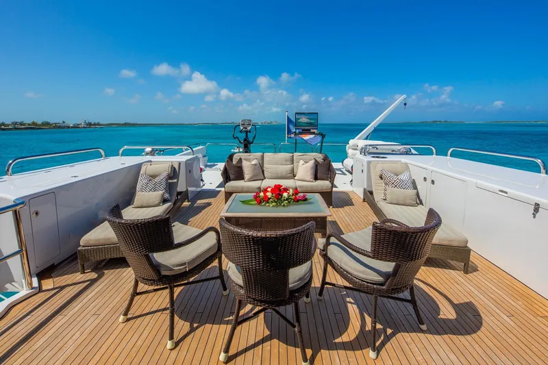 Starship Yacht Photos Pics Luxury yacht deck with wicker seating, ocean view; Van Mill Custom, 1988 model.