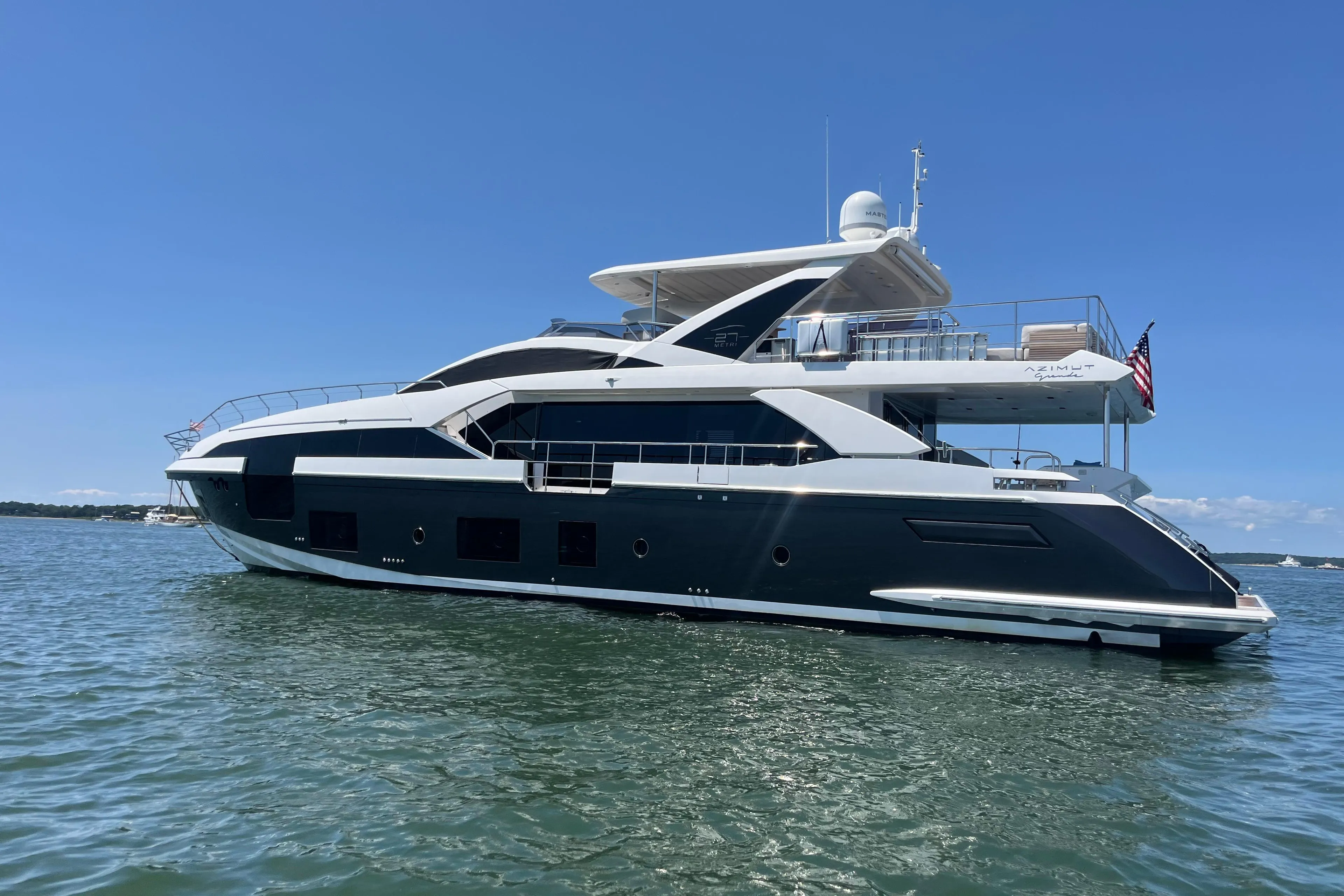 Azimut Grande 27M 2019 yacht on water under clear blue sky.