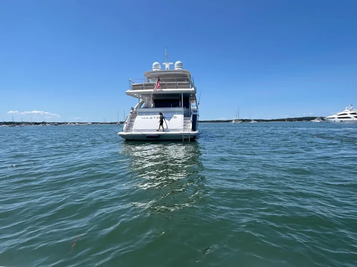 Mastermind Yacht Photos Pics Azimut Grande 27M yacht on water, 2019 model, clear blue sky background.