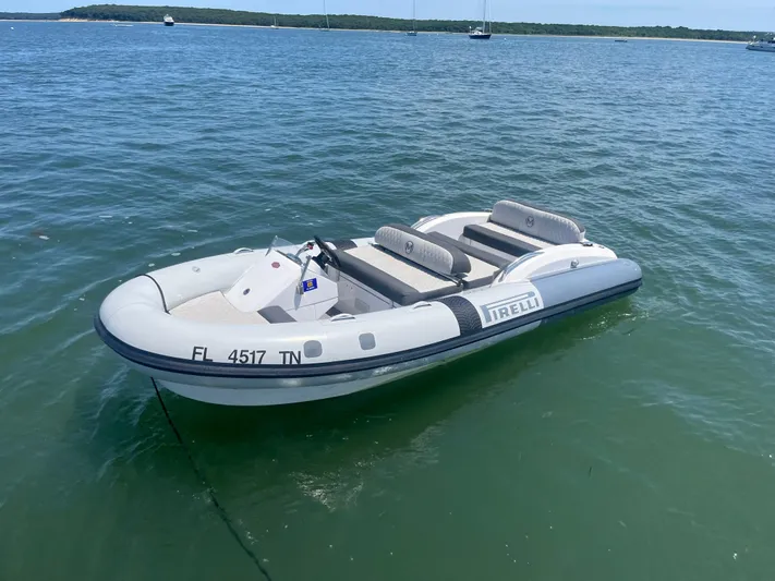 Mastermind Yacht Photos Pics Inflatable boat on water, featuring Pirelli branding, near Azimut Grande 27M yacht.