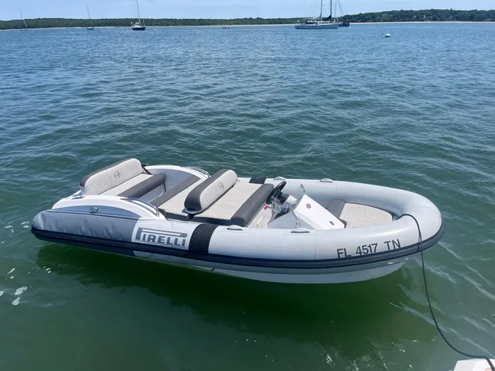 Mastermind Yacht Photos Pics Inflatable boat on water, labeled "Pirelli," near Azimut Grande 27M yacht, 2019 model.