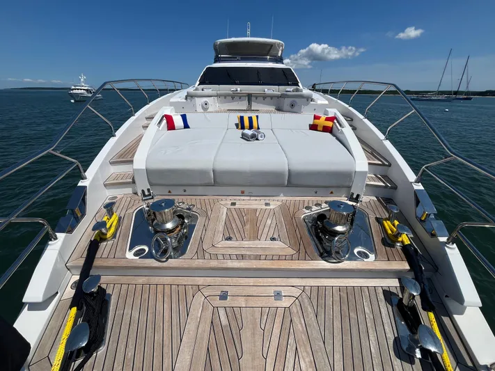 Mastermind Yacht Photos Pics Luxurious 2019 Azimut Grande 27M yacht deck with plush seating and nautical flags.
