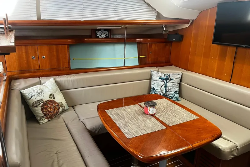 Honu Yacht Photos Pics Cozy interior of 2006 Hunter 41 Deck Salon with dining area and nautical decor.