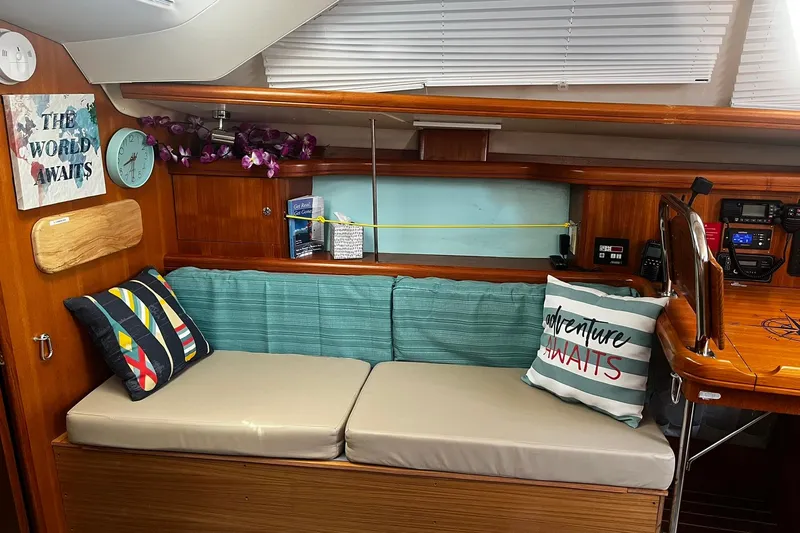 Honu Yacht Photos Pics Cozy interior of 2006 Hunter 41 Deck Salon with nautical decor and cushions.