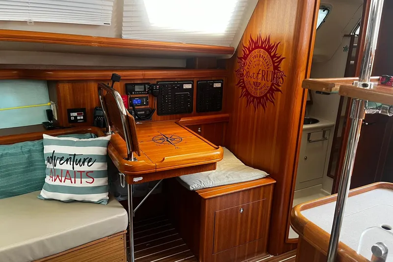 Honu Yacht Photos Pics Interior of 2006 Hunter 41 Deck Salon with navigation station and cozy seating area.