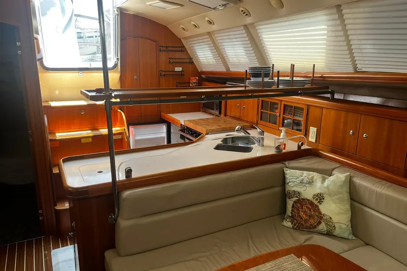 Honu Yacht Photos Pics Interior of 2006 Hunter 41 Deck Salon yacht with modern kitchen and seating area.